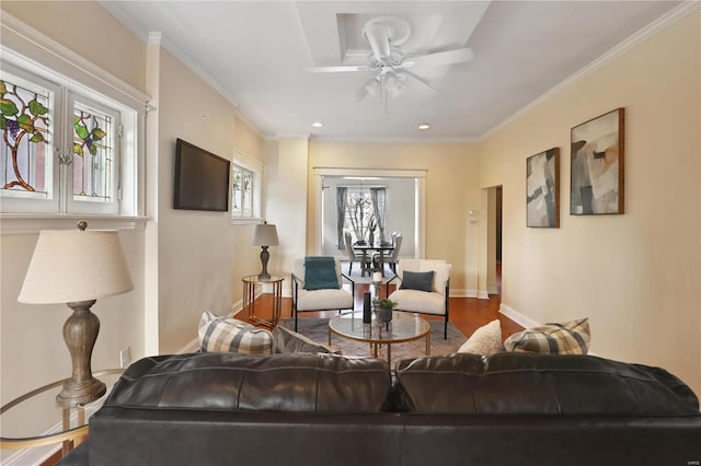 living room with hardwood / wood-style floors, ceiling fan, and crown molding