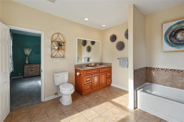 bathroom with tile patterned floors, vanity, toilet, and a bath