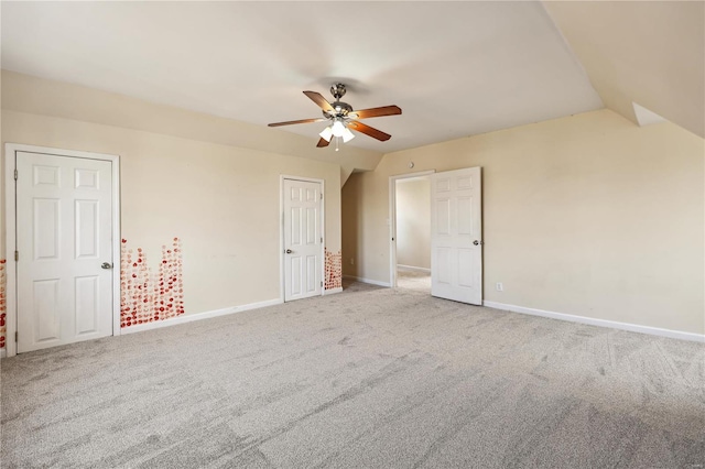 unfurnished bedroom with carpet flooring, vaulted ceiling, and ceiling fan