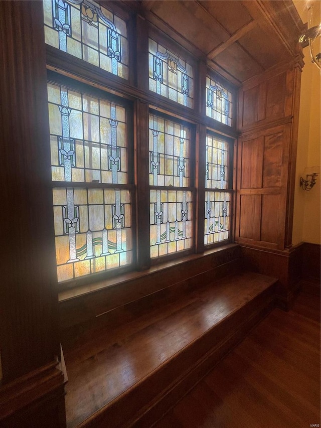 interior details with hardwood / wood-style floors and wooden walls