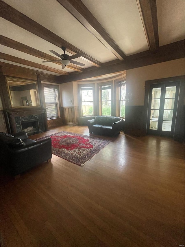 living room featuring dark wood-type flooring, beamed ceiling, french doors, and ceiling fan