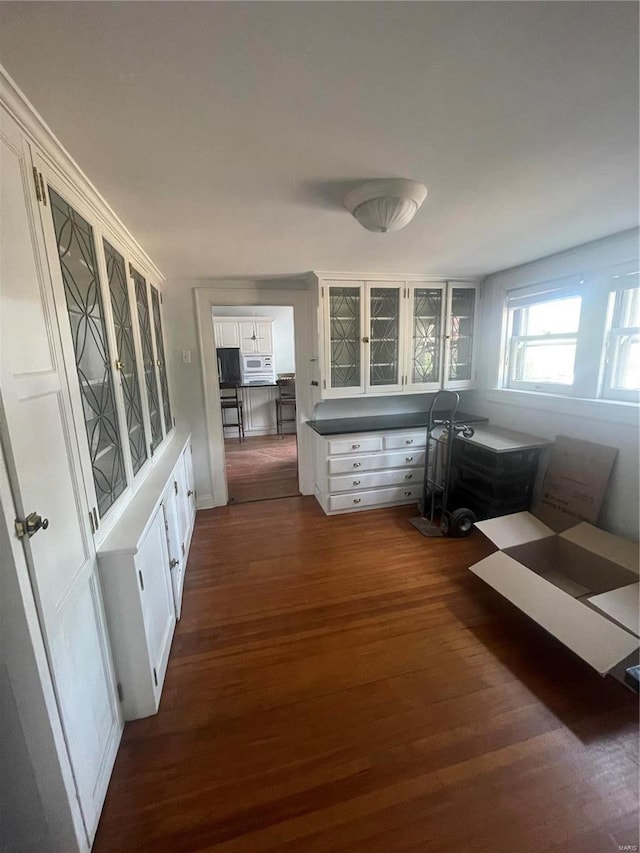 hallway with dark hardwood / wood-style floors