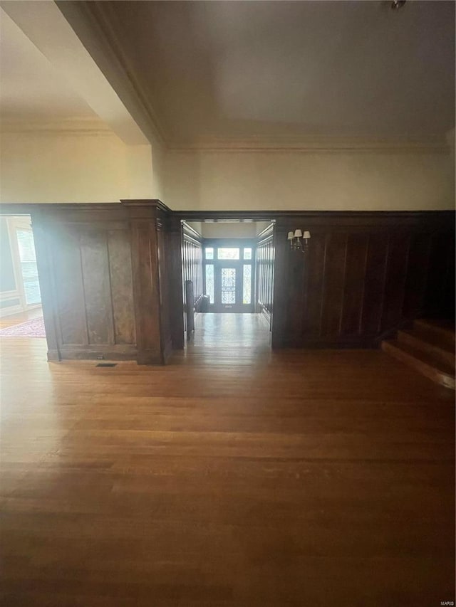 corridor with hardwood / wood-style flooring