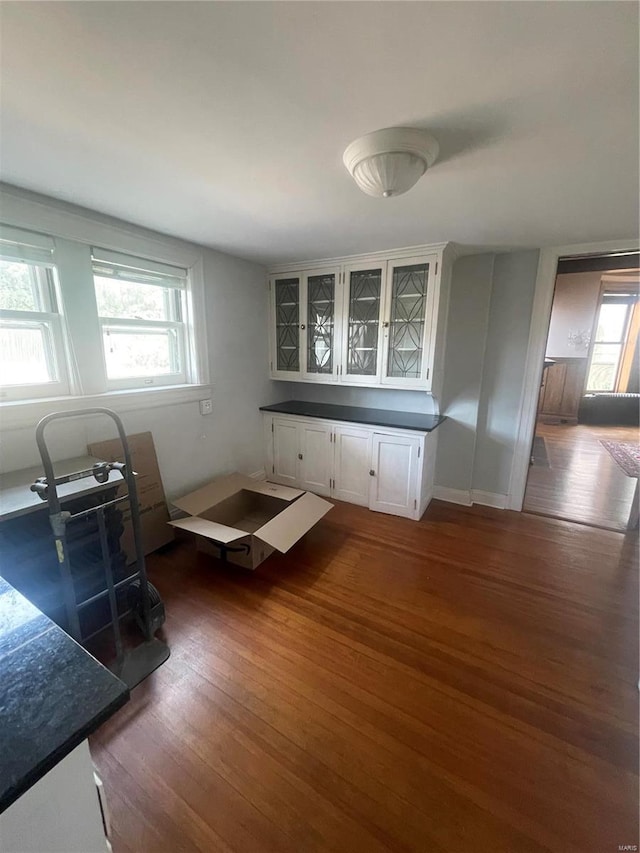 kitchen featuring white cabinetry and dark hardwood / wood-style flooring