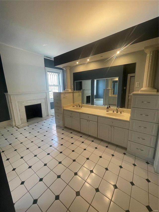 bathroom featuring vanity and ornate columns