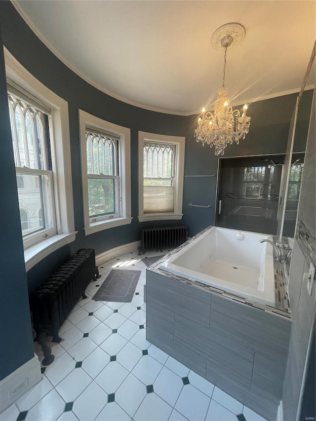 bathroom featuring radiator heating unit, tiled bath, a notable chandelier, and crown molding