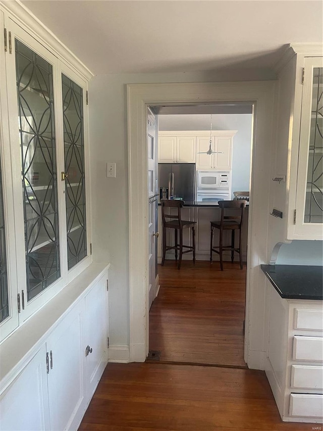 corridor with dark hardwood / wood-style floors