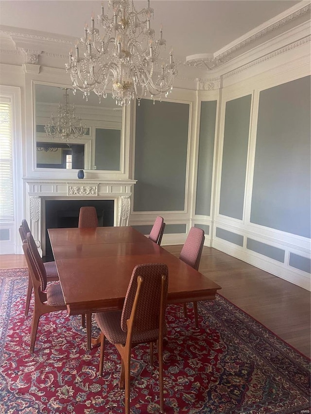 dining room with hardwood / wood-style floors and a chandelier