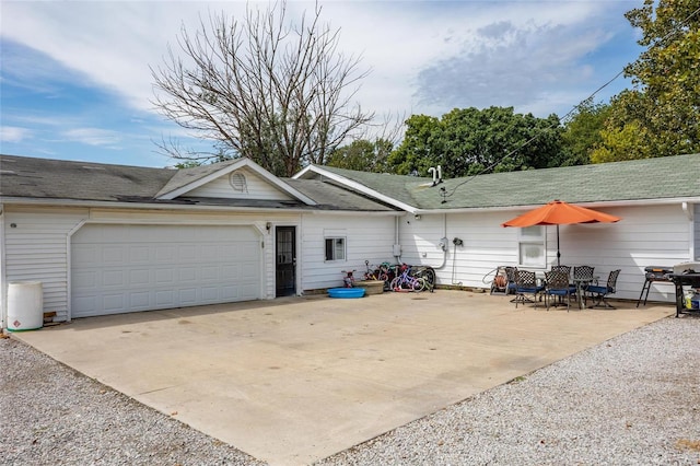 rear view of property with a garage