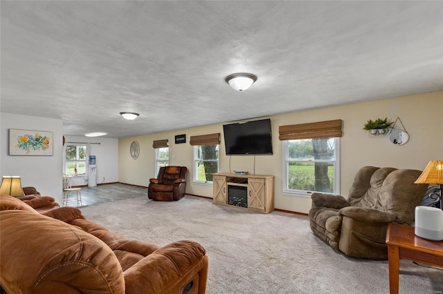 living room featuring carpet and a textured ceiling