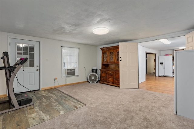 workout room featuring cooling unit and light colored carpet