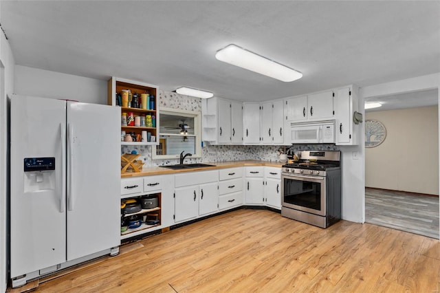 kitchen featuring light wood-type flooring, white appliances, sink, and white cabinets