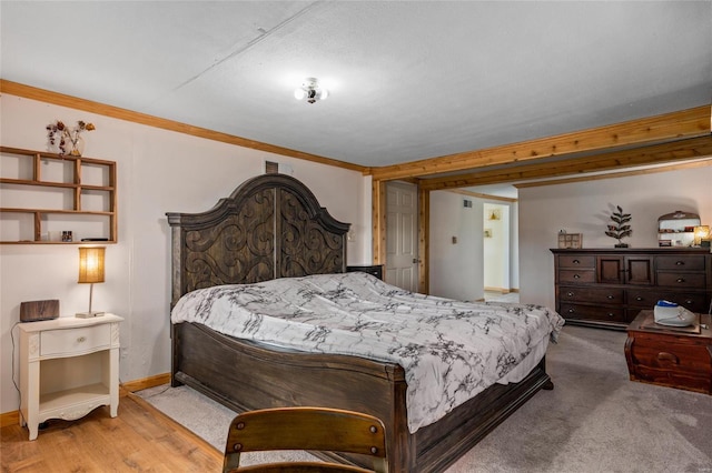 bedroom featuring crown molding and light hardwood / wood-style floors