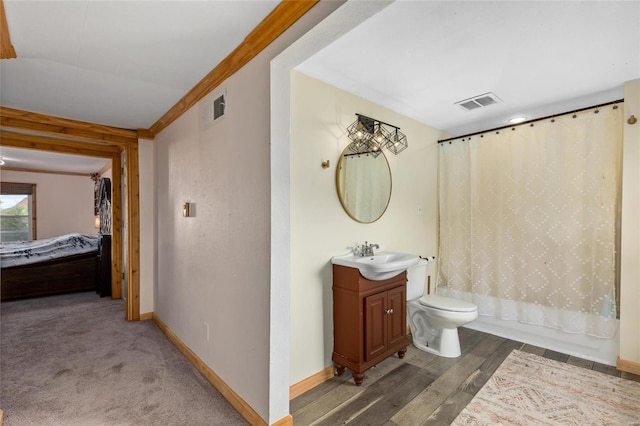 full bathroom with vanity, shower / tub combo with curtain, toilet, ornamental molding, and hardwood / wood-style flooring