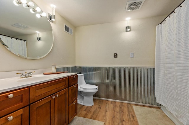 bathroom featuring vanity, toilet, and hardwood / wood-style flooring