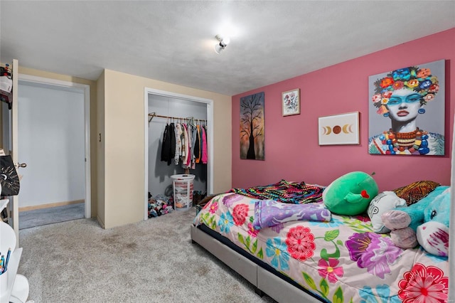 carpeted bedroom with a textured ceiling and a closet