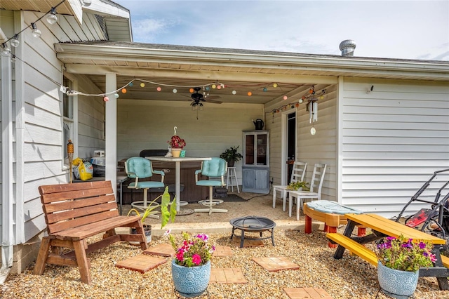 view of patio / terrace with ceiling fan and an outdoor fire pit