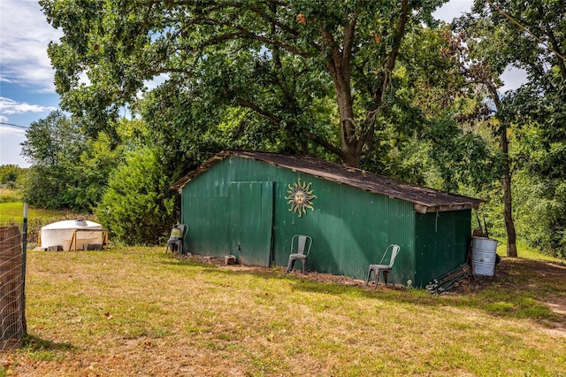 view of outdoor structure featuring a lawn