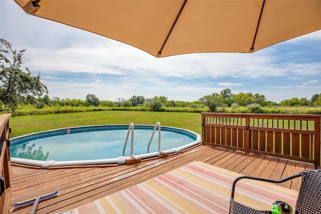 view of pool featuring a yard and a deck