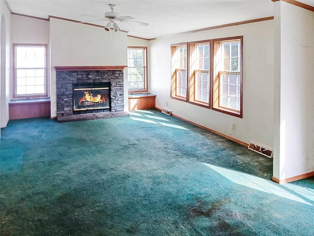 unfurnished living room with a fireplace, carpet, crown molding, lofted ceiling, and ceiling fan