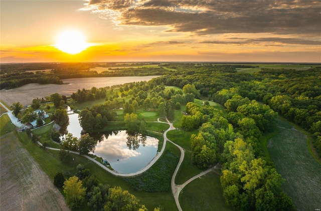 aerial view at dusk featuring a water view