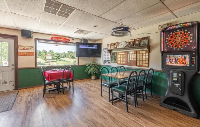 interior space with hardwood / wood-style flooring and a drop ceiling