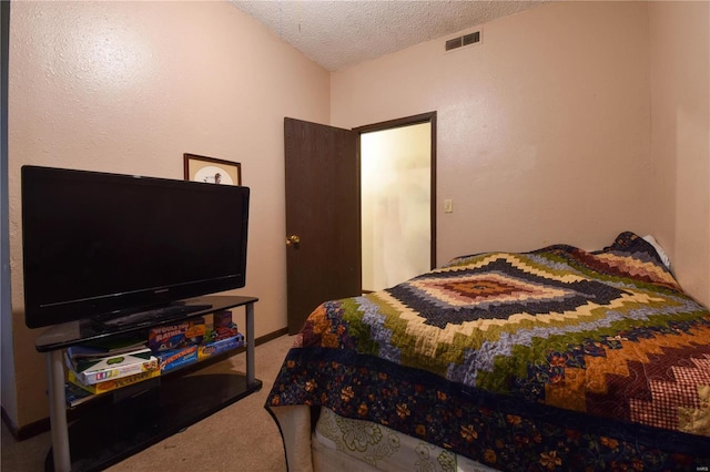 bedroom featuring a textured ceiling and carpet floors