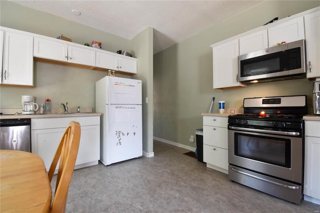 kitchen with white cabinets, a textured ceiling, and appliances with stainless steel finishes