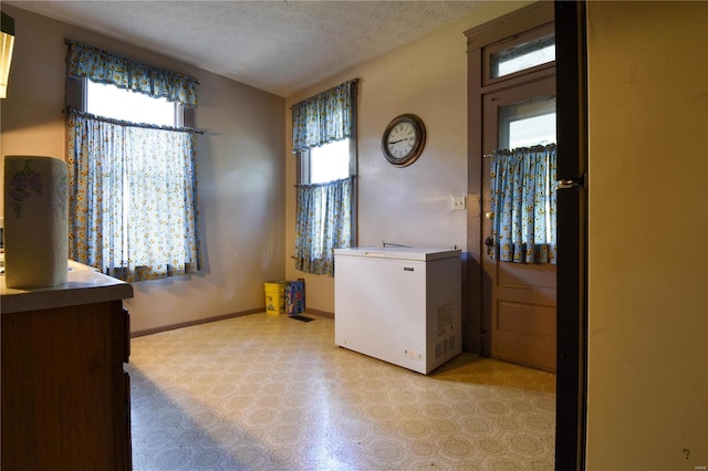 clothes washing area featuring a textured ceiling