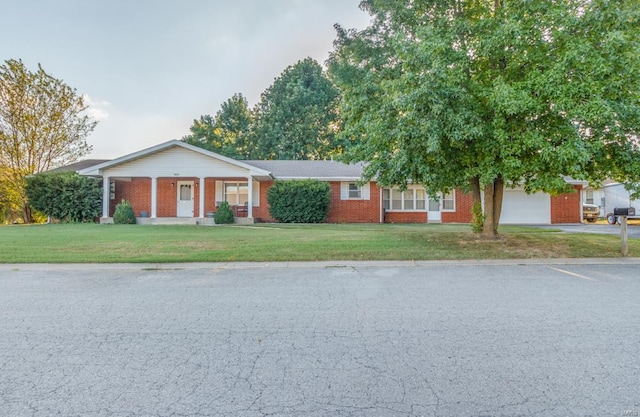 single story home with a front yard and a garage