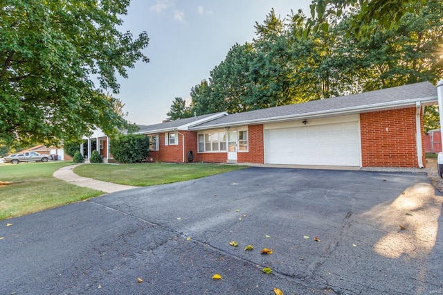 ranch-style home with a garage and a front yard