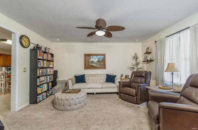 carpeted living room featuring ceiling fan