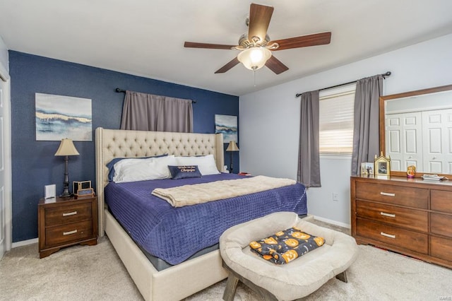 carpeted bedroom with ceiling fan and a closet