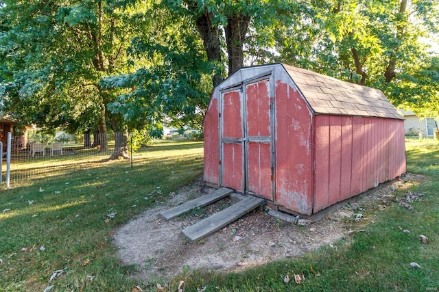 view of outbuilding featuring a yard