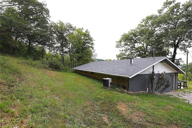 view of property exterior featuring a yard and central AC unit