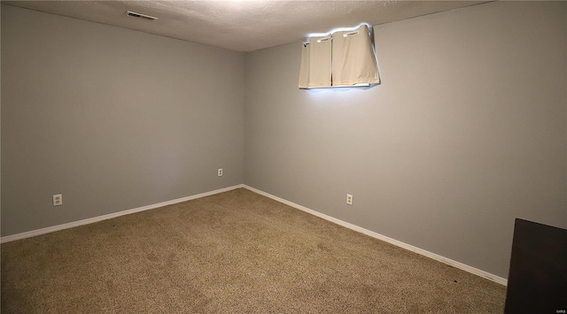 carpeted spare room with a textured ceiling