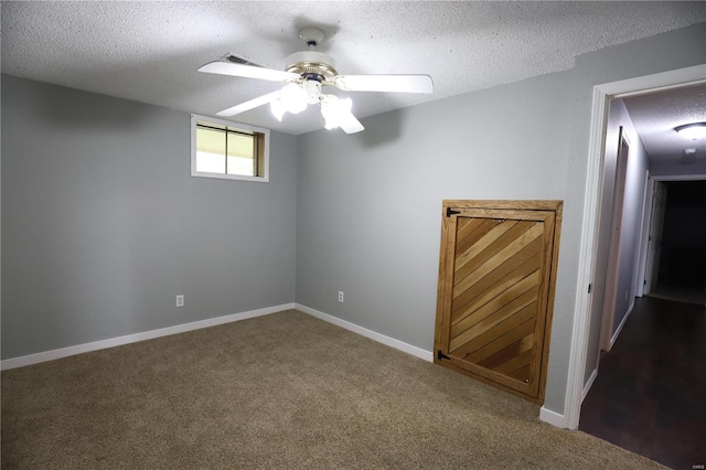 carpeted empty room with a textured ceiling and ceiling fan