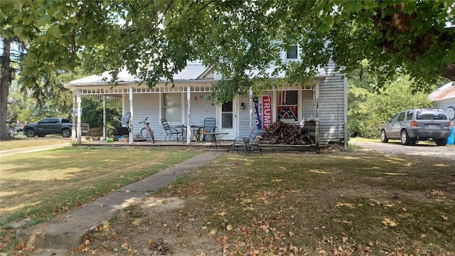 view of front of property with a porch and a front yard