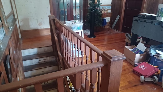 staircase featuring wood-type flooring