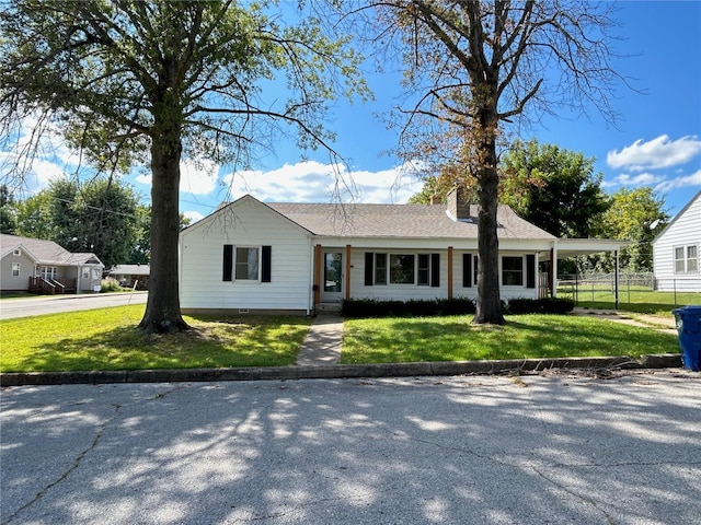 ranch-style house with a carport and a front lawn