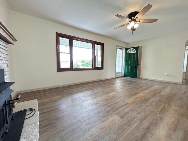 unfurnished living room featuring hardwood / wood-style floors and ceiling fan