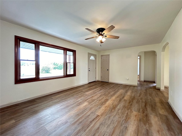 empty room with ceiling fan and hardwood / wood-style flooring