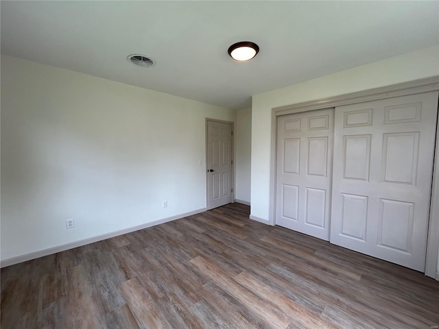 unfurnished bedroom with a closet and wood-type flooring