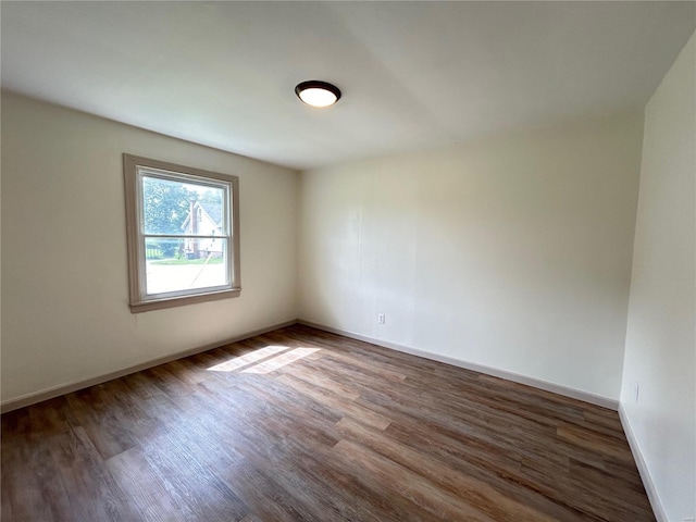 spare room with dark wood-type flooring