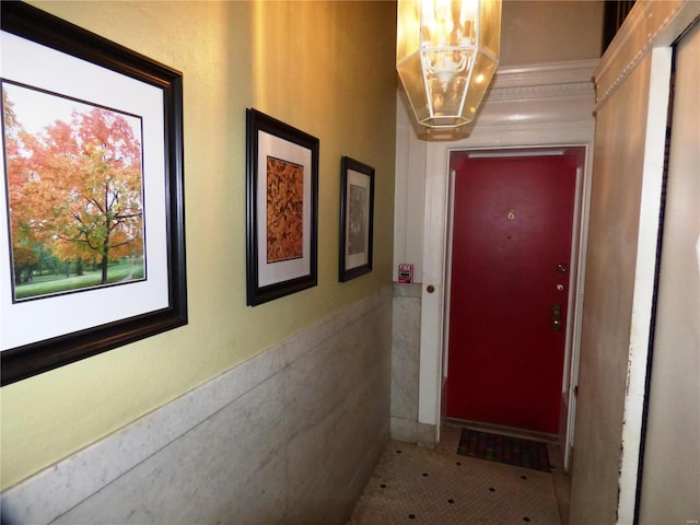 interior space featuring tile walls, tile patterned flooring, and a chandelier