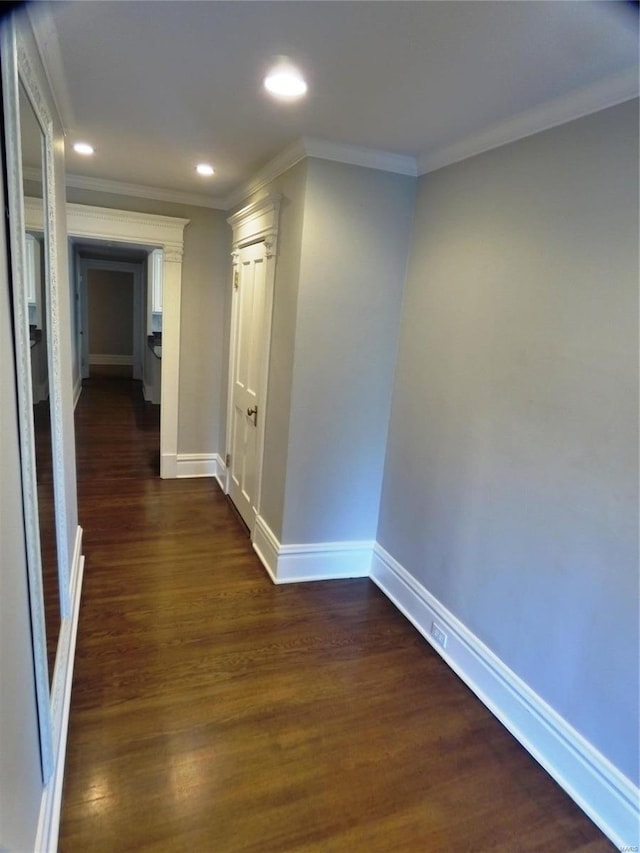 corridor with ornamental molding and dark hardwood / wood-style flooring