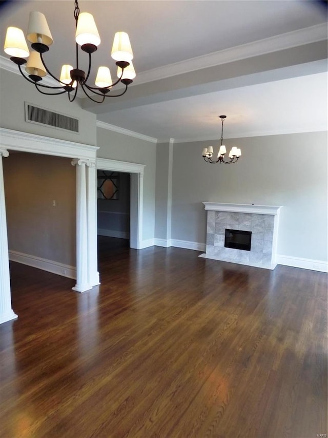 unfurnished living room with dark hardwood / wood-style floors, a fireplace, an inviting chandelier, and ornamental molding