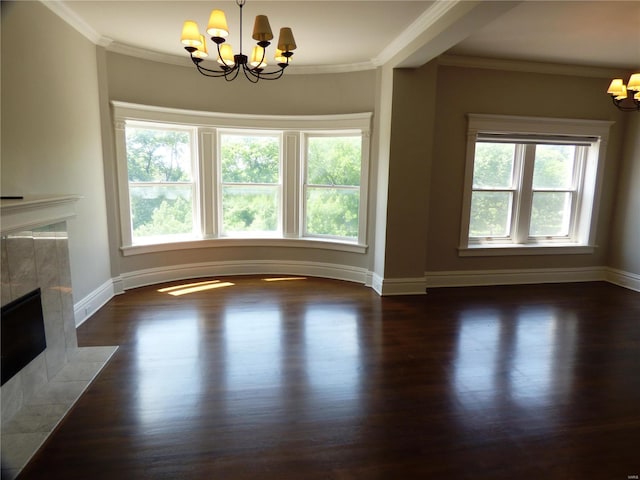 unfurnished living room with a tiled fireplace, a healthy amount of sunlight, and a notable chandelier