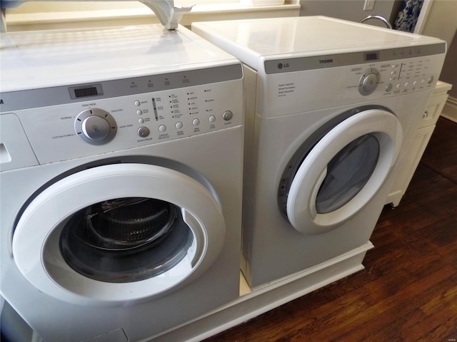 washroom featuring dark wood-type flooring and separate washer and dryer