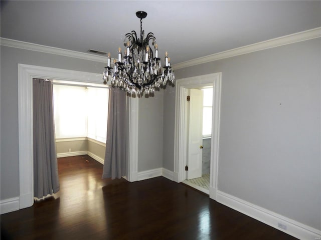 unfurnished dining area with hardwood / wood-style floors, crown molding, and a notable chandelier